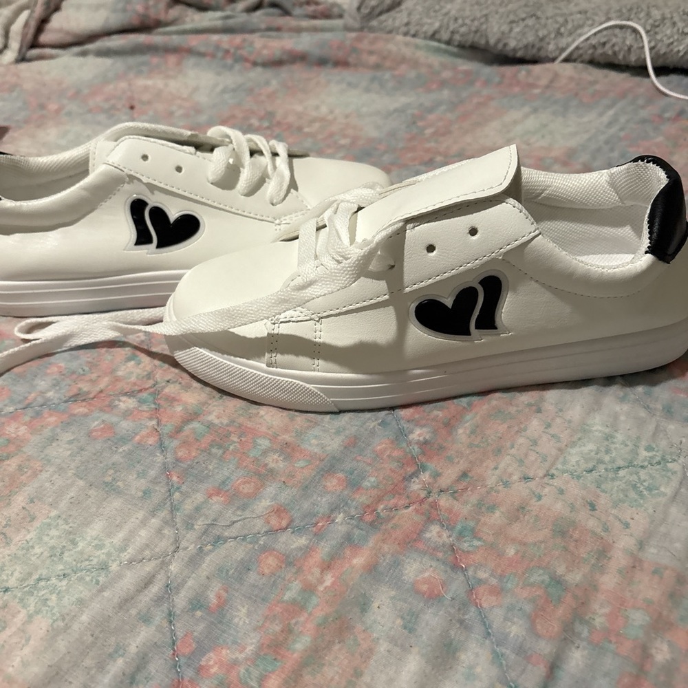 White sneakers with double hearts. Never been worn. Wrong size for me.
